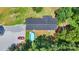 Aerial view features a dark roofed home with a pool and a red car at 2932 Rant Drum Rd, Maiden, NC 28650