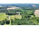 Sprawling property showcasing a home, pond, fields, and lush woodlands in a picturesque aerial shot at 2932 Rant Drum Rd, Maiden, NC 28650