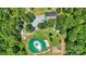 Aerial view of a property showcasing a home, swimming pool, pond with fountain, and surrounding trees at 2932 Rant Drum Rd, Maiden, NC 28650