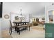 Bright dining area open to the living room features stylish furniture and natural light from the large window at 2932 Rant Drum Rd, Maiden, NC 28650