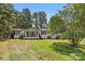 Inviting single-story home featuring a cozy front porch and manicured lawn at 2932 Rant Drum Rd, Maiden, NC 28650
