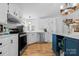 Well-lit kitchen features white cabinetry, stainless steel appliances, and a contrasting blue kitchen island at 2932 Rant Drum Rd, Maiden, NC 28650
