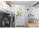 Bright laundry room featuring a modern washer and dryer, ample storage, and convenient exterior access at 2932 Rant Drum Rd, Maiden, NC 28650