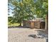 Charming log cabin outbuilding is nestled near trees and a gravel area at 2932 Rant Drum Rd, Maiden, NC 28650