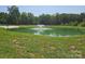 Scenic view of a pond featuring a fountain and lush green surroundings, creating a peaceful ambiance at 2932 Rant Drum Rd, Maiden, NC 28650
