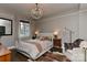 Comfortable bedroom featuring a chandelier, hardwood floors, and plenty of natural light from the window at 301 W 10Th St # 404, Charlotte, NC 28202