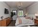 Bedroom with hardwood floors, a chandelier, a dresser, a large window, and gray colored walls at 301 W 10Th St # 404, Charlotte, NC 28202