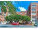 Stunning brick building with manicured trees and patriotic bunting accents at 301 W 10Th St # 404, Charlotte, NC 28202