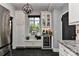 Well-appointed kitchen includes a wine refrigerator, granite countertops, custom cabinets, and black slate flooring at 301 W 10Th St # 404, Charlotte, NC 28202