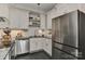 Bright kitchen features stainless steel appliances, white cabinets, black granite countertops, and dark slate flooring at 301 W 10Th St # 404, Charlotte, NC 28202