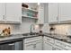 Bright and modern kitchen featuring granite counters, white subway backsplash, stainless appliances, and stylish white cabinetry at 301 W 10Th St # 404, Charlotte, NC 28202