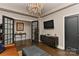 Living room with a chandelier, hardwood floors, entertainment area, and glass paneled doors at 301 W 10Th St # 404, Charlotte, NC 28202