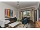 Bright living room with bay window, decorative curtains, hardwood floors, and contemporary decor at 301 W 10Th St # 404, Charlotte, NC 28202