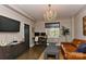 Living Room featuring a chandelier, desk, comfortable seating, and entertainment area at 301 W 10Th St # 404, Charlotte, NC 28202