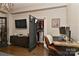 Home office with desk, open closet, hardwood flooring, and a tv at 301 W 10Th St # 404, Charlotte, NC 28202