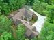Bird's-eye view showing the home surrounded by trees, unique rooflines, long driveway and verdant landscaping at 3394 Rainbow Dr, Waxhaw, NC 28173