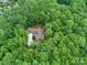 An overhead shot of a secluded home nestled among lush greenery and trees. A private retreat at 3394 Rainbow Dr, Waxhaw, NC 28173