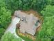 Overhead shot showcasing a custom home with meticulously manicured landscaping in a private, wooded setting at 3394 Rainbow Dr, Waxhaw, NC 28173