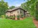 Manicured backyard featuring a patio set, lush lawn and professionally landscaped plantings at 3394 Rainbow Dr, Waxhaw, NC 28173