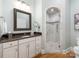 Bathroom with granite countertop vanity, decorative mirror and walk-in tiled shower at 3394 Rainbow Dr, Waxhaw, NC 28173