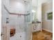 Bathroom featuring glass shower with tile walls, granite countertop, white cabinets, and window at 3394 Rainbow Dr, Waxhaw, NC 28173