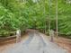 A private drive leads to a secluded, wooded property with a gated entrance, signaling privacy and tranquility at 3394 Rainbow Dr, Waxhaw, NC 28173