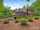 Exterior view of home's back side showing the patio, treed lot and professional landscaping at 3394 Rainbow Dr, Waxhaw, NC 28173