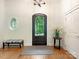 Inviting foyer features decorative front door, wood floors, and neutral paint scheme at 3394 Rainbow Dr, Waxhaw, NC 28173