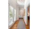 Bright hallway with hardwood floors and lots of natural light through large windows at 3394 Rainbow Dr, Waxhaw, NC 28173