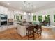 Gourmet kitchen with white cabinets, granite counters, stainless appliances and island seating at 3394 Rainbow Dr, Waxhaw, NC 28173