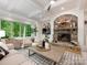 Bright living room featuring stone fireplace, large windows, and recessed lighting at 3394 Rainbow Dr, Waxhaw, NC 28173
