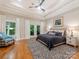 A serene main bedroom with trey ceilings, balcony access, and hardwood floors throughout at 3394 Rainbow Dr, Waxhaw, NC 28173