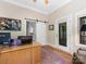 Home office featuring wooden desk, rug, barn door to kitchen and exterior door to balcony at 3394 Rainbow Dr, Waxhaw, NC 28173