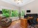 Bright home office with large windows, wooden floors, ceiling fan and a comfortable desk area at 3394 Rainbow Dr, Waxhaw, NC 28173