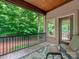Cozy screened-in porch features wood ceiling, tiled floor, seating, and a lush green view at 3394 Rainbow Dr, Waxhaw, NC 28173