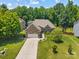 Aerial view of a well-maintained home with lush green lawn and mature trees in a quiet neighborhood at 3633 Longpond Ln, Monroe, NC 28110
