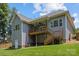 Back exterior with spacious deck, stairs, large windows, and a gray siding at 3633 Longpond Ln, Monroe, NC 28110
