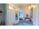 Updated bathroom has marble tile shower, blue vanity, and modern fixtures at 3633 Longpond Ln, Monroe, NC 28110