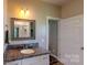 Well-lit bathroom features granite countertops, wood cabinetry, and a glass shower at 3633 Longpond Ln, Monroe, NC 28110