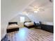 Attic bedroom with two twin beds, a desk, and light-colored wood floors at 3633 Longpond Ln, Monroe, NC 28110
