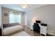 Bright bedroom or office with natural light, plush day bed, and functional work space at 3633 Longpond Ln, Monroe, NC 28110