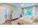 Bedroom with a white dresser, large window, and door to the exterior at 3633 Longpond Ln, Monroe, NC 28110
