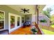 Covered deck area with outdoor seating, ceiling fan, and backyard view at 3633 Longpond Ln, Monroe, NC 28110