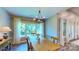 Sunlit dining room with a large table, wooden chairs, and serene outdoor view at 3633 Longpond Ln, Monroe, NC 28110