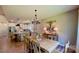 Bright dining area open to kitchen, featuring a wooden table and modern lighting at 3633 Longpond Ln, Monroe, NC 28110