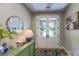 Charming foyer with decorative mirror, white paneled double doors, and console table at 3633 Longpond Ln, Monroe, NC 28110