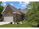 Charming brick home with manicured landscaping, a two-car garage, and inviting front entrance at 3633 Longpond Ln, Monroe, NC 28110