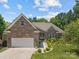 Charming brick home with a two-car garage, well-manicured lawn, and inviting front entrance at 3633 Longpond Ln, Monroe, NC 28110