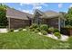Charming brick home featuring a well-manicured lawn and landscaped flower beds at 3633 Longpond Ln, Monroe, NC 28110