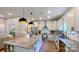 Modern kitchen featuring granite countertops, stainless steel appliances, and stylish pendant lighting at 3633 Longpond Ln, Monroe, NC 28110